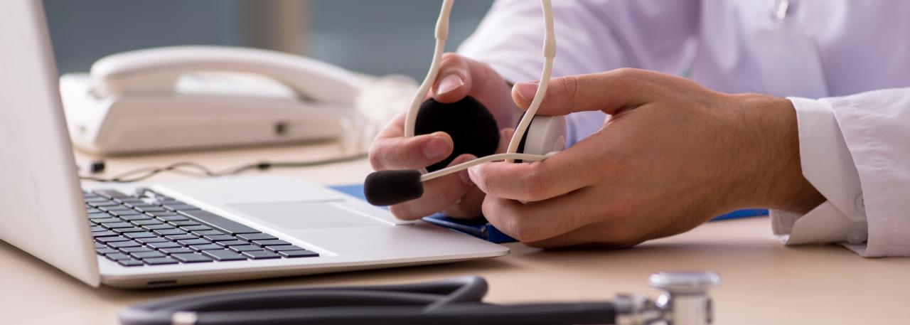 doctor holding headset for virtual care