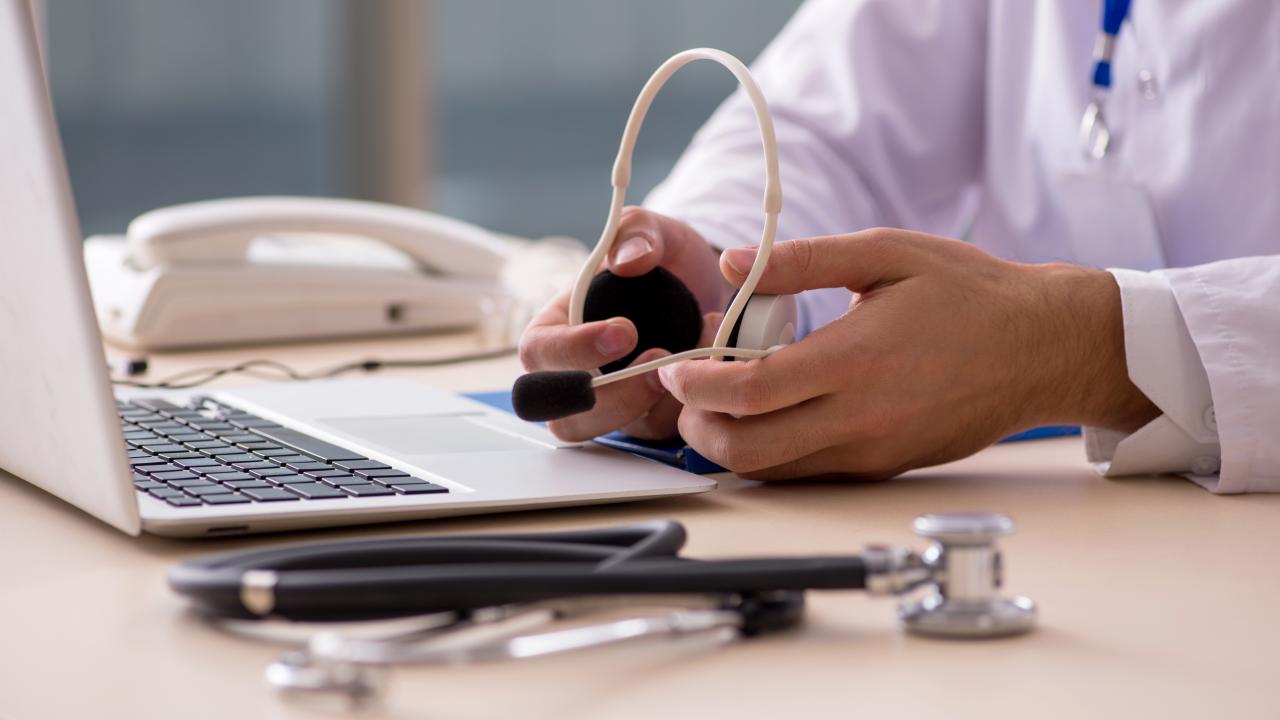 doctor holding headset for virtual care